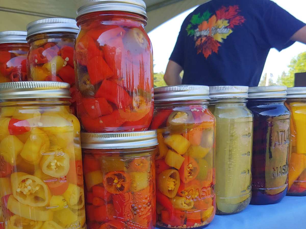 jars of pickled produce on a market table